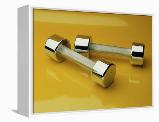 Hand Weights on a Reflective Yellow Surface-null-Framed Premier Image Canvas