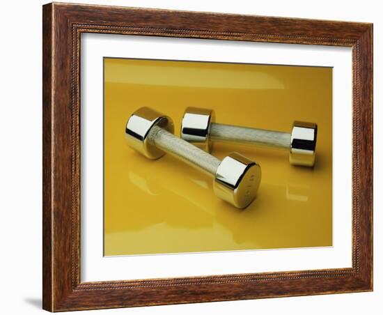 Hand Weights on a Reflective Yellow Surface-null-Framed Photographic Print