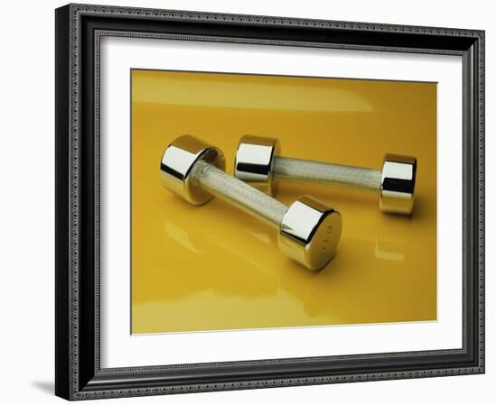 Hand Weights on a Reflective Yellow Surface-null-Framed Photographic Print