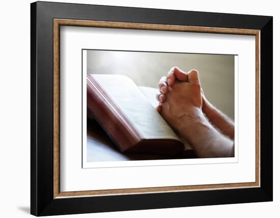 Hands Praying on a Holy Bible-null-Framed Art Print