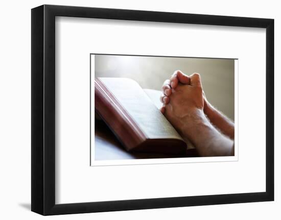 Hands Praying on a Holy Bible-null-Framed Art Print