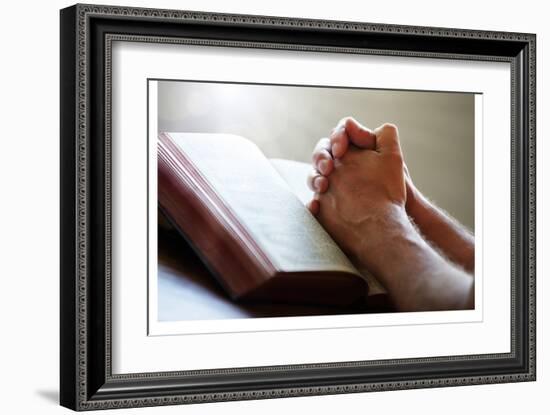 Hands Praying on a Holy Bible-null-Framed Art Print