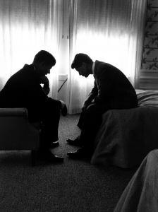 Jack Kennedy Conferring with His Brother and Campaign Organizer Bobby Kennedy in Hotel Suite by Hank Walker