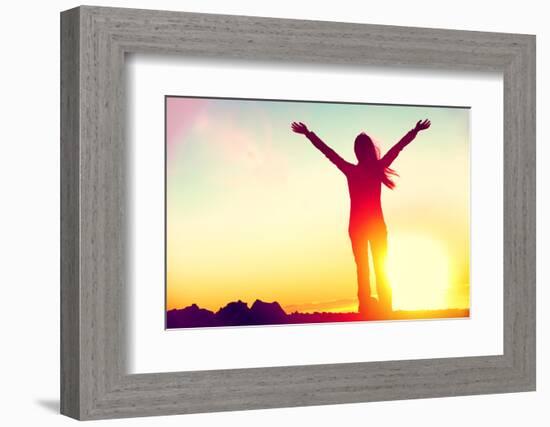 Happy Celebrating Winning Success Woman at Sunset or Sunrise Standing Elated with Arms Raised up Ab-Maridav-Framed Photographic Print