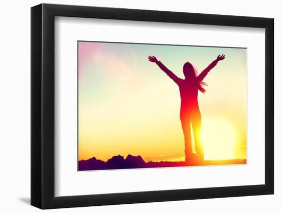 Happy Celebrating Winning Success Woman at Sunset or Sunrise Standing Elated with Arms Raised up Ab-Maridav-Framed Photographic Print