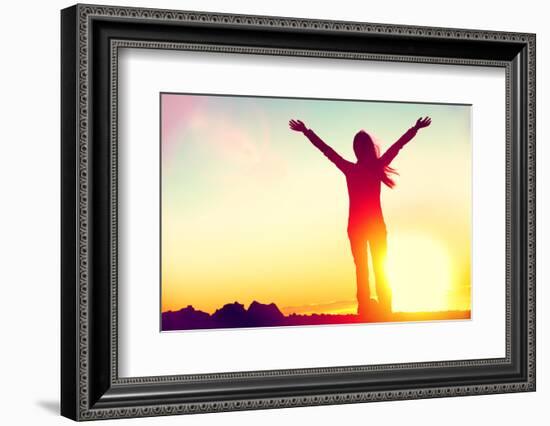 Happy Celebrating Winning Success Woman at Sunset or Sunrise Standing Elated with Arms Raised up Ab-Maridav-Framed Photographic Print