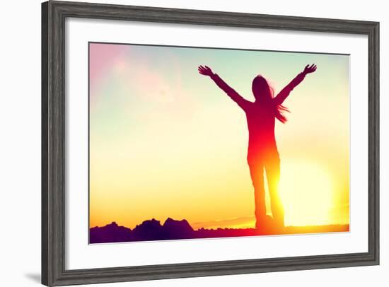 Happy Celebrating Winning Success Woman at Sunset or Sunrise Standing Elated with Arms Raised up Ab-Maridav-Framed Photographic Print