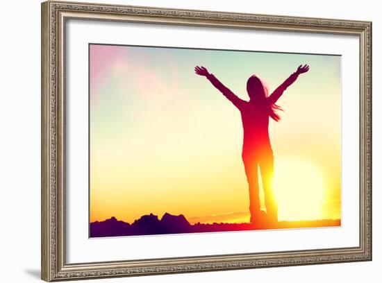 Happy Celebrating Winning Success Woman at Sunset or Sunrise Standing Elated with Arms Raised up Ab-Maridav-Framed Photographic Print