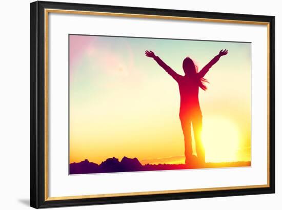 Happy Celebrating Winning Success Woman at Sunset or Sunrise Standing Elated with Arms Raised up Ab-Maridav-Framed Photographic Print