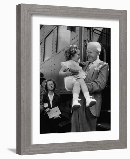 Harry Truman Holding up 3 Yr Old Suzanne Bump after the Town's Postmaster Pressed Her into Service-Hank Walker-Framed Photographic Print