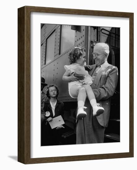 Harry Truman Holding up 3 Yr Old Suzanne Bump after the Town's Postmaster Pressed Her into Service-Hank Walker-Framed Photographic Print