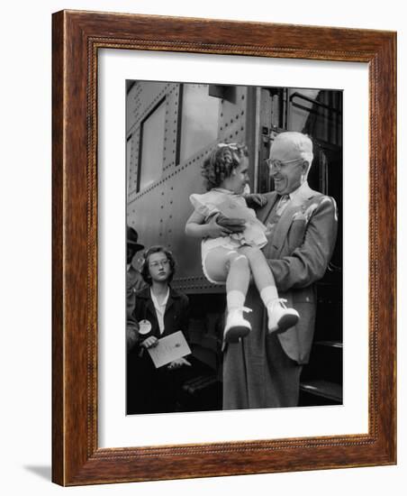 Harry Truman Holding up 3 Yr Old Suzanne Bump after the Town's Postmaster Pressed Her into Service-Hank Walker-Framed Photographic Print