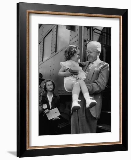 Harry Truman Holding up 3 Yr Old Suzanne Bump after the Town's Postmaster Pressed Her into Service-Hank Walker-Framed Photographic Print