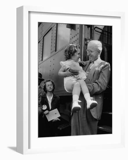 Harry Truman Holding up 3 Yr Old Suzanne Bump after the Town's Postmaster Pressed Her into Service-Hank Walker-Framed Photographic Print