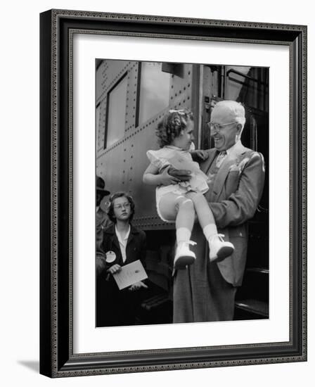 Harry Truman Holding up 3 Yr Old Suzanne Bump after the Town's Postmaster Pressed Her into Service-Hank Walker-Framed Photographic Print