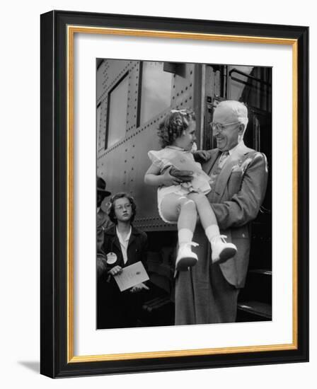 Harry Truman Holding up 3 Yr Old Suzanne Bump after the Town's Postmaster Pressed Her into Service-Hank Walker-Framed Photographic Print