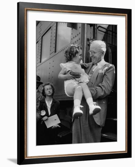 Harry Truman Holding up 3 Yr Old Suzanne Bump after the Town's Postmaster Pressed Her into Service-Hank Walker-Framed Photographic Print