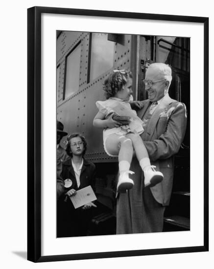 Harry Truman Holding up 3 Yr Old Suzanne Bump after the Town's Postmaster Pressed Her into Service-Hank Walker-Framed Photographic Print