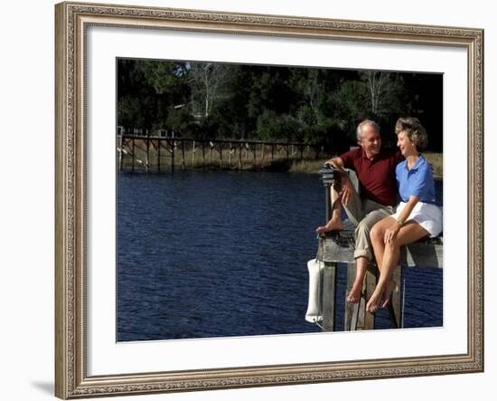 Healthy Couple Sitting on the Dock by a Lake-Bill Bachmann-Framed Photographic Print