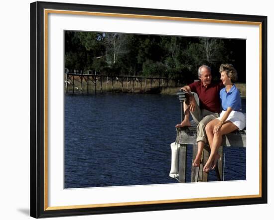 Healthy Couple Sitting on the Dock by a Lake-Bill Bachmann-Framed Photographic Print