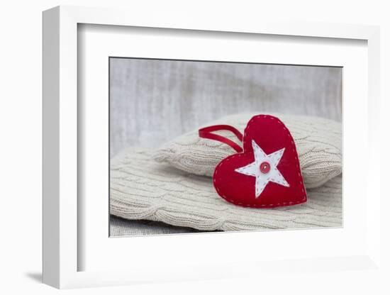 Heart cushions with star of Bethlehem as a token of love, still life-Andrea Haase-Framed Photographic Print