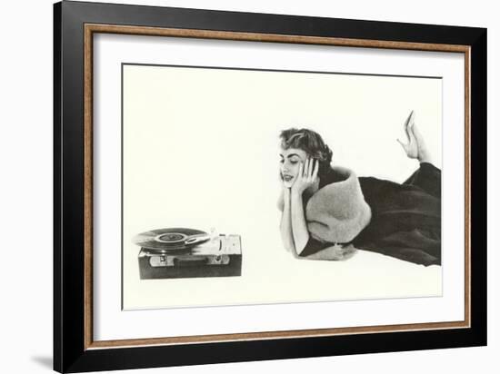 Heavily Browed Lady Listening to Record Player-null-Framed Art Print