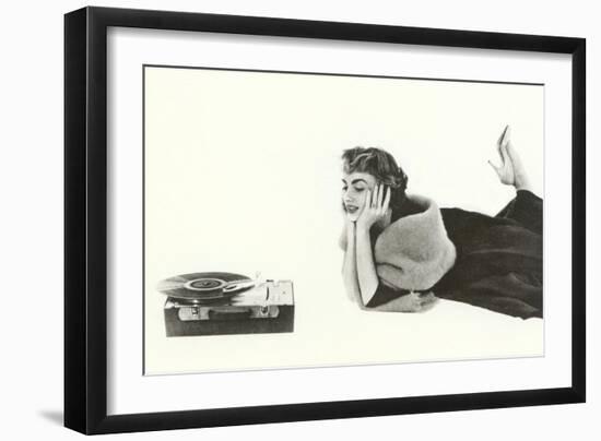 Heavily Browed Lady Listening to Record Player-null-Framed Art Print