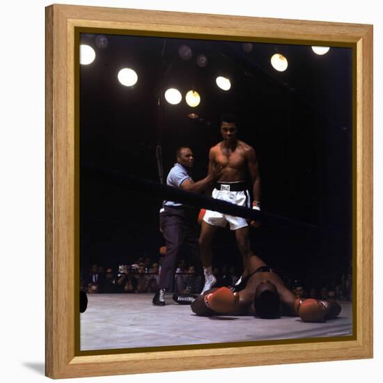 Heavyweight Boxer Cassius Clay, aka Muhammad Ali, Standing over Opponent Sonny Liston-George Silk-Framed Premier Image Canvas