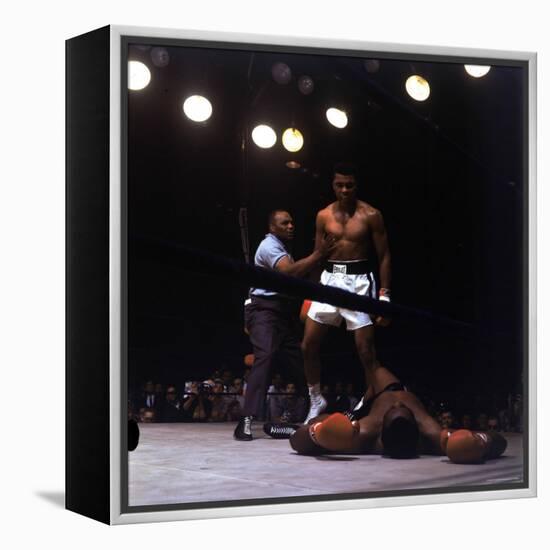 Heavyweight Boxer Cassius Clay, aka Muhammad Ali, Standing over Opponent Sonny Liston-George Silk-Framed Premier Image Canvas