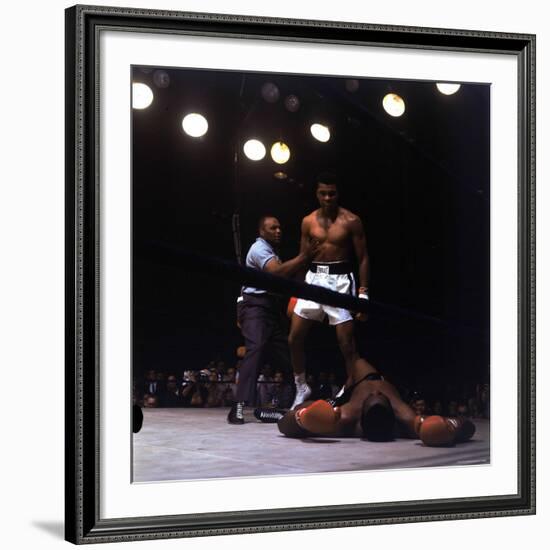 Heavyweight Boxer Cassius Clay, aka Muhammad Ali, Standing over Opponent Sonny Liston-George Silk-Framed Premium Photographic Print