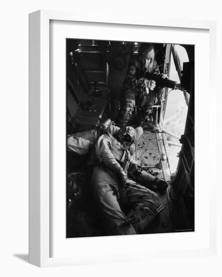 Helicopter Chief James C. Farley Working Jammed Machine as Pilot Lt. James Magel Dying Beside Him-Larry Burrows-Framed Photographic Print