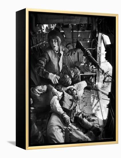 Helicopter Crew Chief James C. Farley Shouting to Crew as Wounded Comrades Lay Dying at His Feet-Larry Burrows-Framed Premier Image Canvas