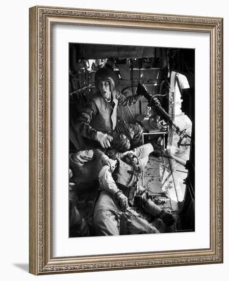 Helicopter Crew Chief James C. Farley Shouting to Crew as Wounded Comrades Lay Dying at His Feet-Larry Burrows-Framed Photographic Print