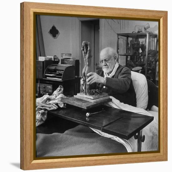 Henri Matisse Sculpting Nude Female Figure While Sitting in Bed in His Apartment-Dmitri Kessel-Framed Premier Image Canvas