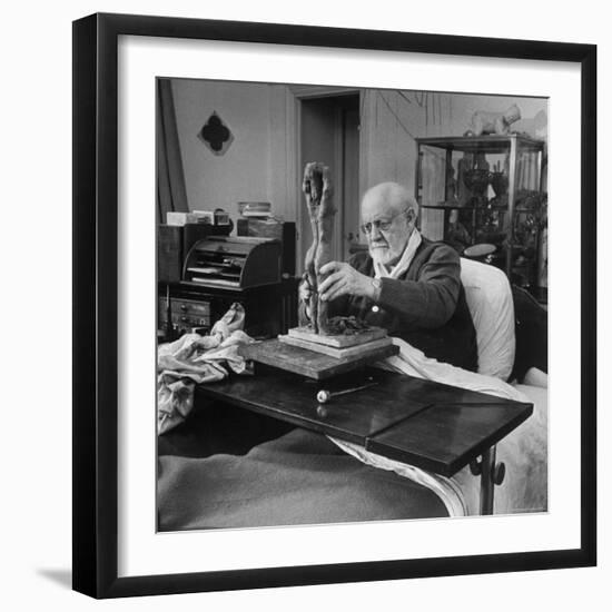 Henri Matisse Sculpting Nude Female Figure While Sitting in Bed in His Apartment-Dmitri Kessel-Framed Premium Photographic Print