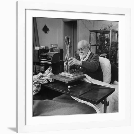 Henri Matisse Sculpting Nude Female Figure While Sitting in Bed in His Apartment-Dmitri Kessel-Framed Premium Photographic Print