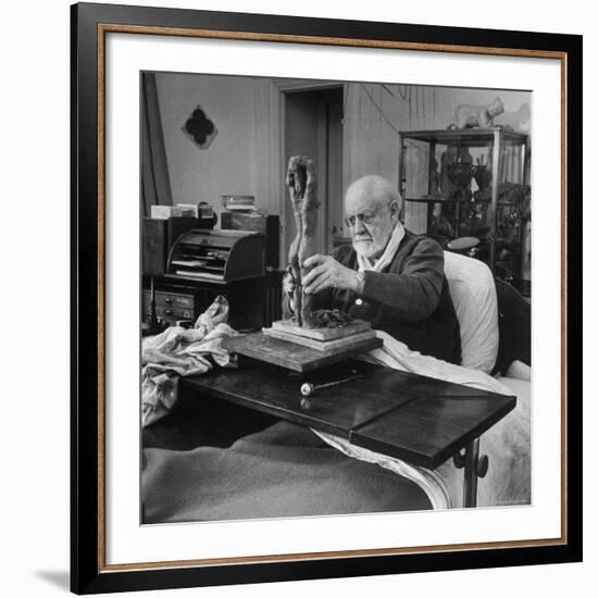 Henri Matisse Sculpting Nude Female Figure While Sitting in Bed in His Apartment-Dmitri Kessel-Framed Premium Photographic Print