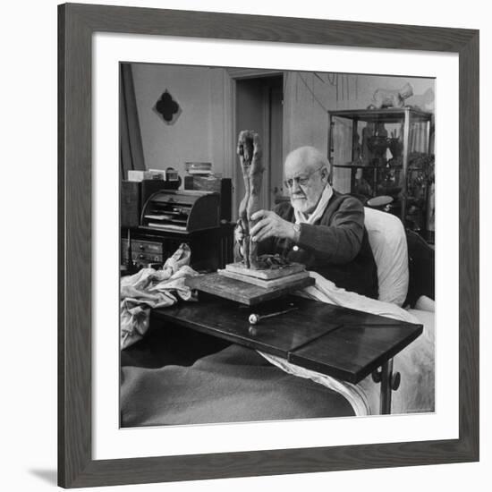 Henri Matisse Sculpting Nude Female Figure While Sitting in Bed in His Apartment-Dmitri Kessel-Framed Premium Photographic Print