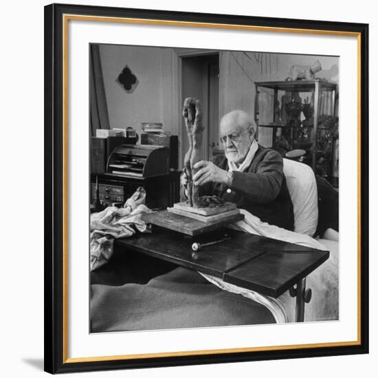 Henri Matisse Sculpting Nude Female Figure While Sitting in Bed in His Apartment-Dmitri Kessel-Framed Premium Photographic Print