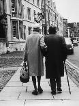 An Elderly Couple Walking Down the Street, Arm in Arm-Henry Grant-Photographic Print