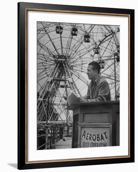 Henry Koerner Standing in Front of Ferris Wheel-null-Framed Premium Photographic Print