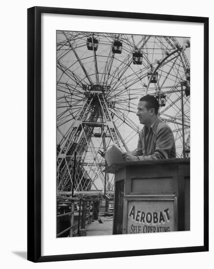 Henry Koerner Standing in Front of Ferris Wheel-null-Framed Premium Photographic Print