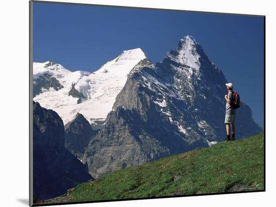 Hiker Looking to the Snow-Covered Monch and the North Face of the Eiger, Swiss Alps, Switzerland-Ruth Tomlinson-Mounted Photographic Print