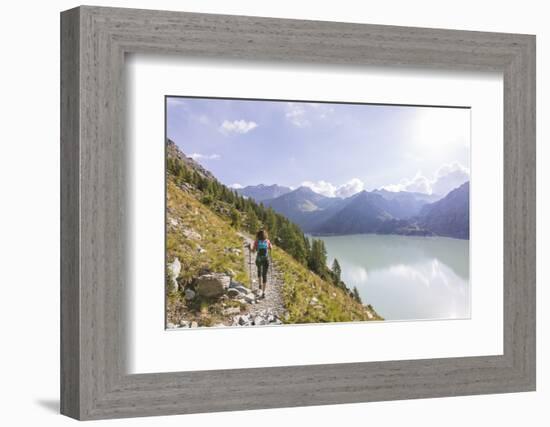 Hiker on path towards Rifugio Bignami beside the dam and water basin of Alpe Gera, Malenco Valley, -Roberto Moiola-Framed Photographic Print