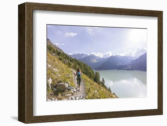 Hiker on path towards Rifugio Bignami beside the dam and water basin of Alpe Gera, Malenco Valley, -Roberto Moiola-Framed Photographic Print