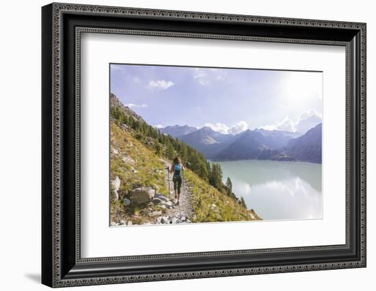 Hiker on path towards Rifugio Bignami beside the dam and water basin of Alpe Gera, Malenco Valley, -Roberto Moiola-Framed Photographic Print