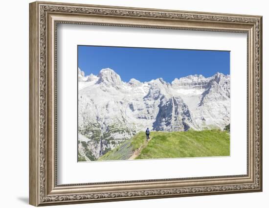 Hiker proceeds on the path to the rocky peaks, Doss Del Sabion, Pinzolo, Brenta Dolomites, Trentino-Roberto Moiola-Framed Photographic Print