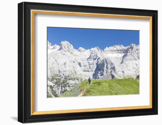 Hiker proceeds on the path to the rocky peaks, Doss Del Sabion, Pinzolo, Brenta Dolomites, Trentino-Roberto Moiola-Framed Photographic Print