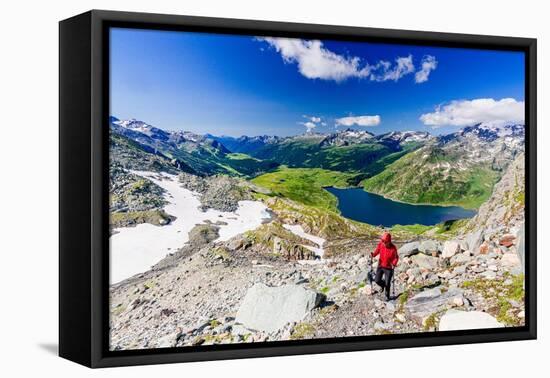 Hiker walking on mountain ridge above the blue lake Montespluga, Madesimo, Valle Spluga, Valtellina-Roberto Moiola-Framed Premier Image Canvas