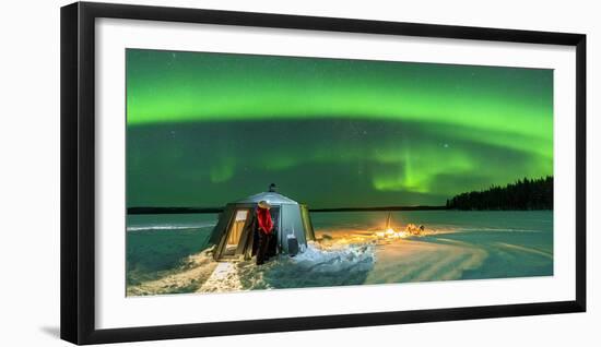 Hiker watching the Aurora Borealis (Northern Lights) close to bonfire and igloo-Roberto Moiola-Framed Photographic Print